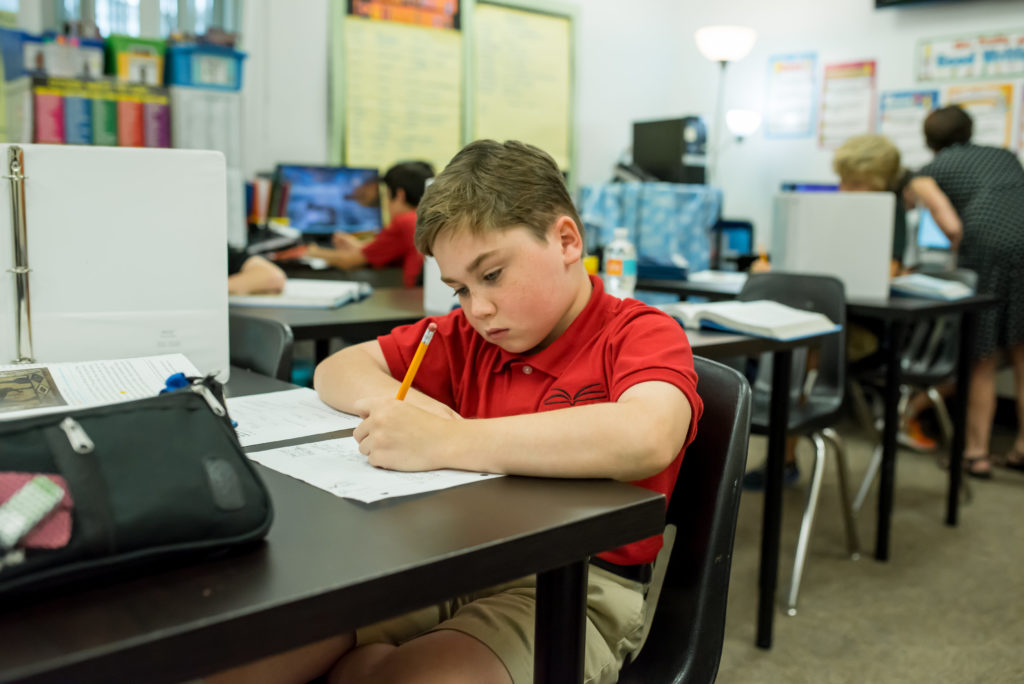 Student writing during class