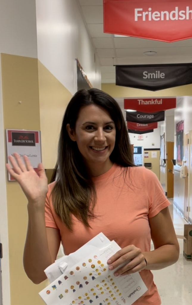 Teacher waves as new school prep begins