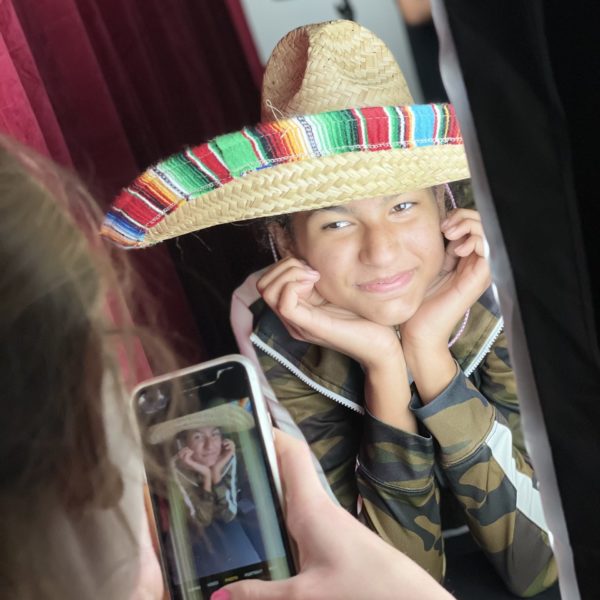 Girl poses for camera in photography class