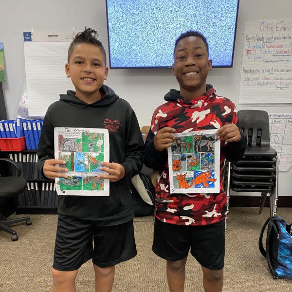 Boys hold up project for class