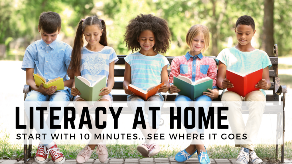 Children sit in a row and read a book each